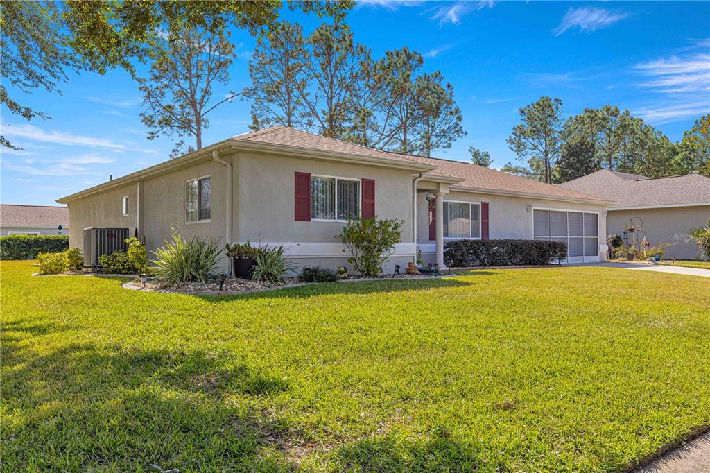 8475 Southeast 137th Loop Summerfield, FL 34491 - Photo 41 of 75 a front view of house with yard and swimming pool