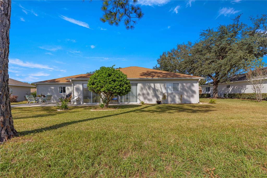 8475 Southeast 137th Loop Summerfield, FL 34491 - Photo 44 of 75 a swimming pool with outdoor seating and yard