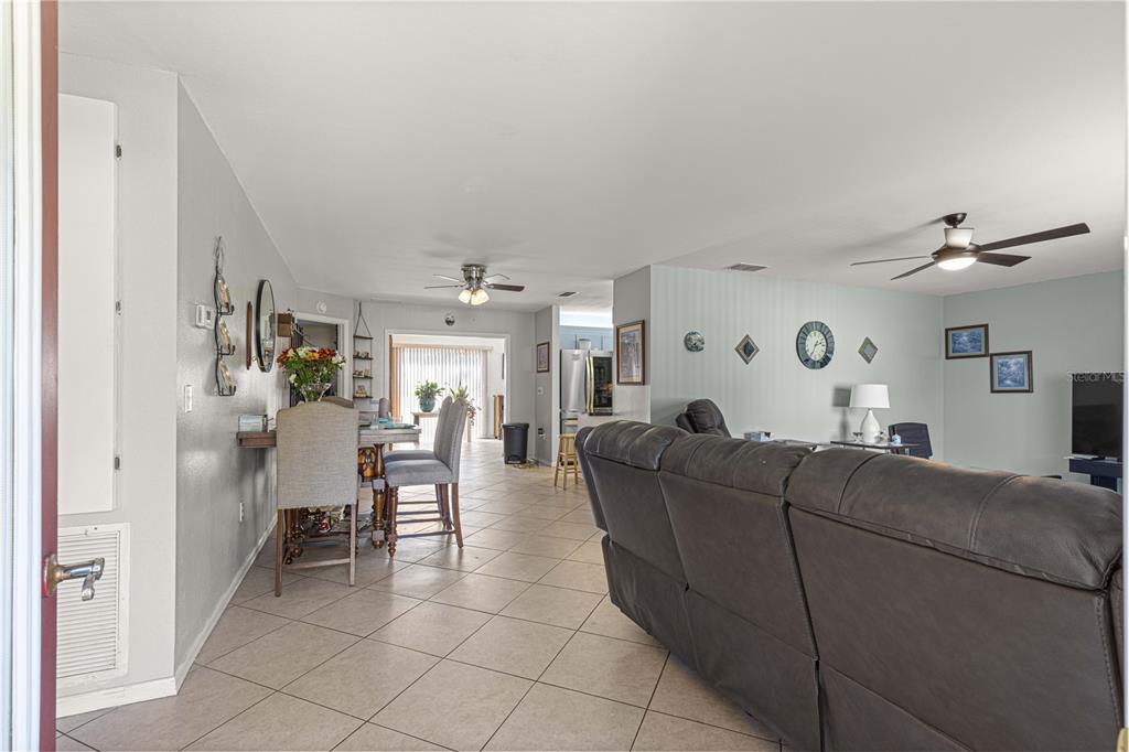 8475 Southeast 137th Loop Summerfield, FL 34491 - Photo 7 of 75 a living room with furniture and a fireplace