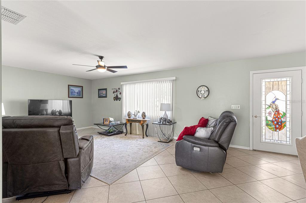 8475 Southeast 137th Loop Summerfield, FL 34491 - Photo 10 of 75 a living room with furniture and a window