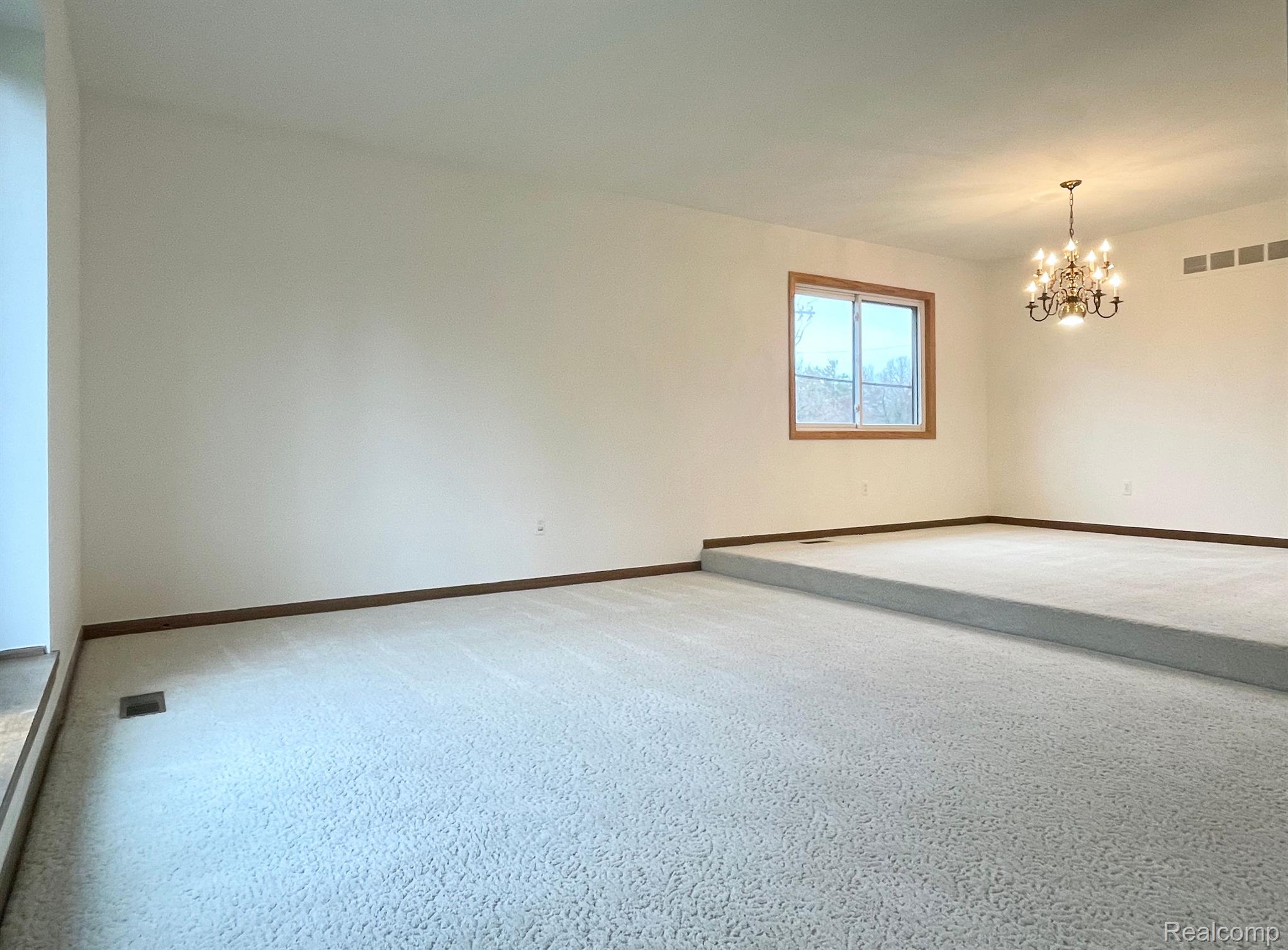 5009 Aintree Road Rochester, MI 48306 - Photo 17 of 41 Living room steps up to dining room