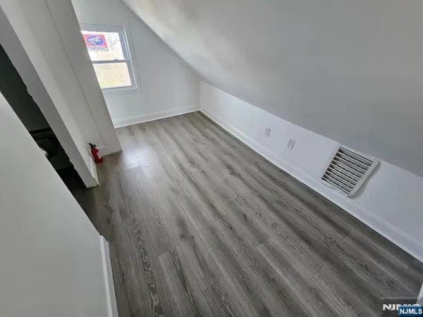 a view of an empty room and wooden floor