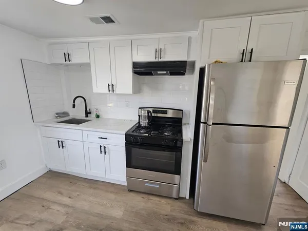 a kitchen with a refrigerator and a sink