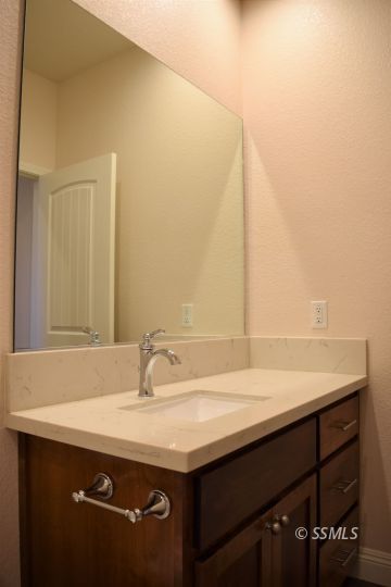 1319 South Farragut Street Ridgecrest, CA 93555 - Photo 16 of 33 a bathroom with a sink and a mirror