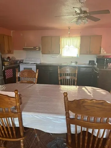 a kitchen with a table chairs sink and cabinets