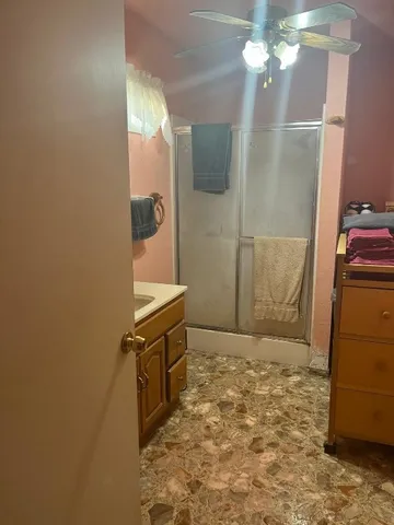 a bathroom with a sink a mirror and shower