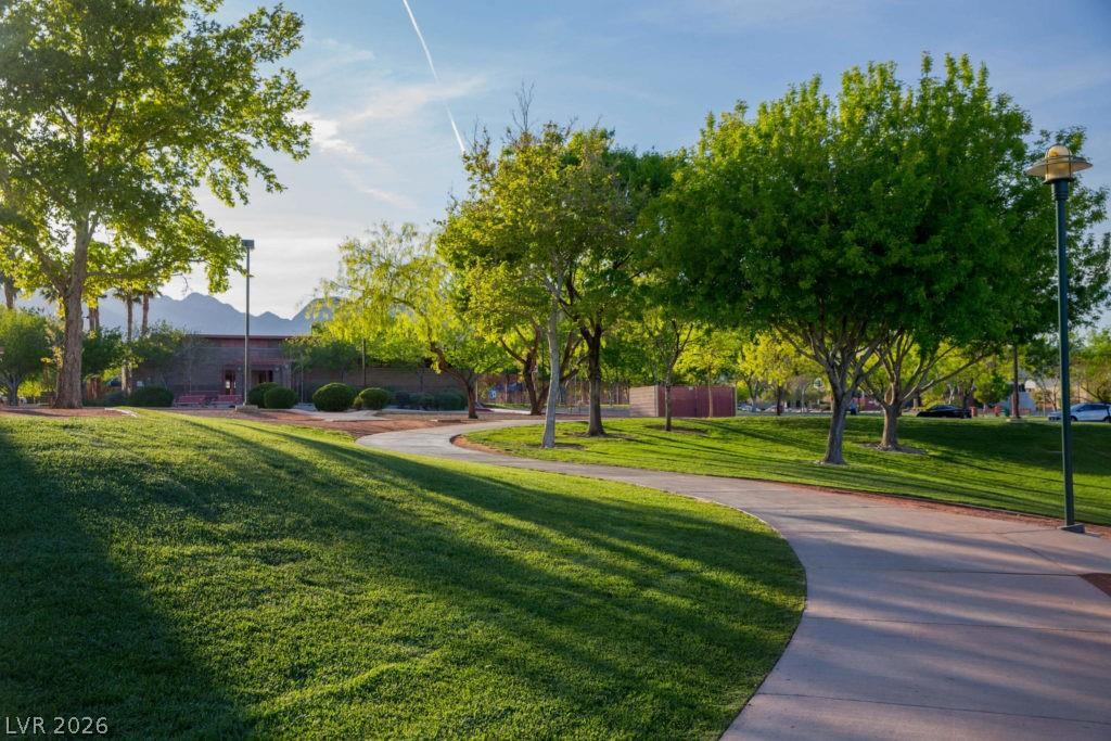 1140 Julie Road Henderson, NV 89002 - Photo 31 of 38 Meandering pathways invite leisurely strolls through lush, manicured parkland with a distant mountain backdrop.