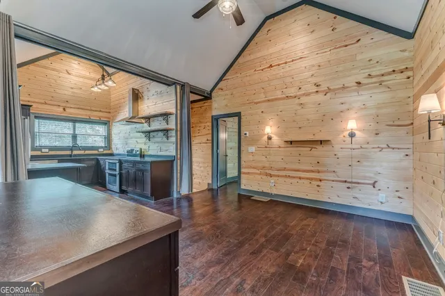 a kitchen with stainless steel appliances granite countertop a sink and a refrigerator