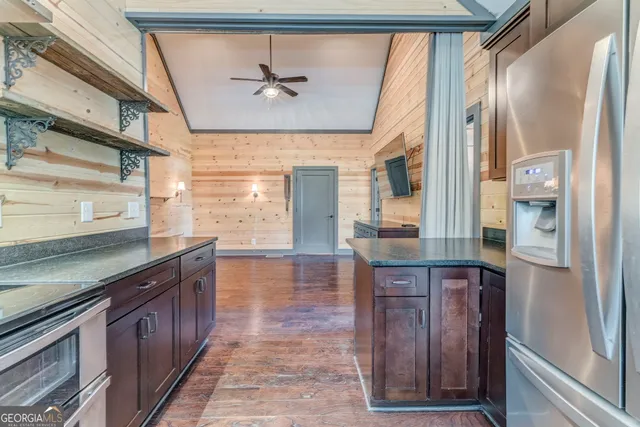 a bathroom with a granite countertop sink and a large mirror