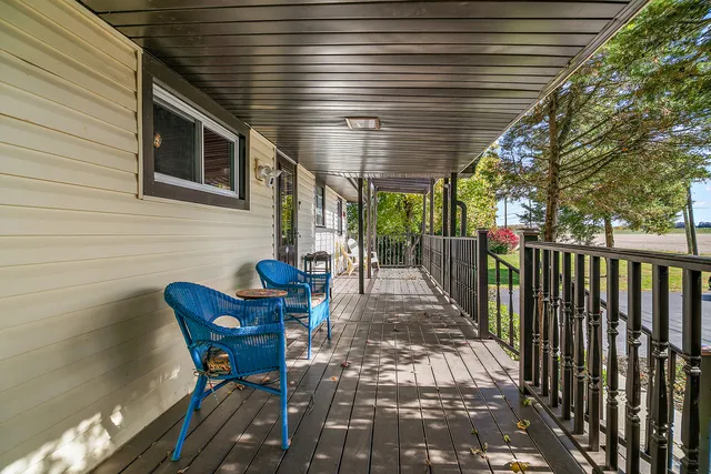 a view of a patio with table and chairs with wooden fence and plants