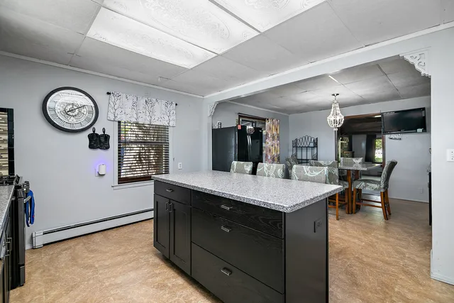a kitchen with a table and a clock on the wall