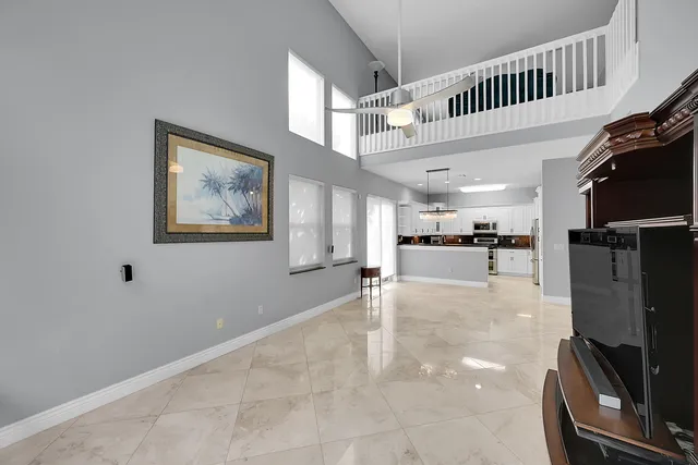 a view of an empty room with a window and a chandelier