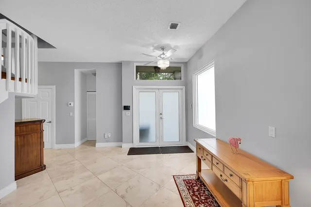 a kitchen with granite countertop a sink a stove and cabinets
