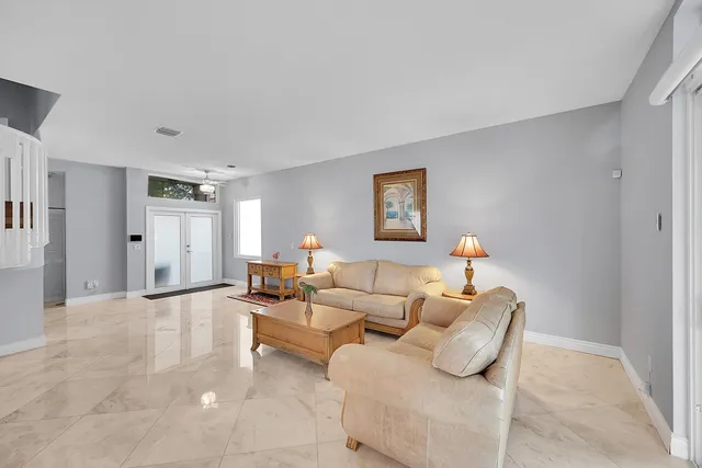 a living room with furniture a dining table and wooden floor