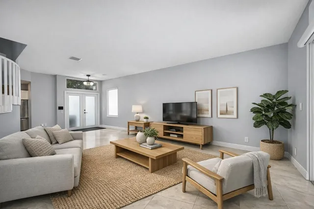 a spacious bedroom with a bed a chandelier and a window