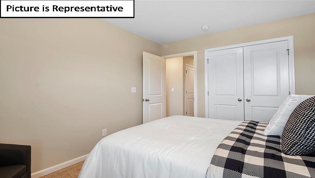 7022 North Mill Road Charlotte, NC 28216 - Photo 22 of 26 a bedroom with a bed and a black white checkered wall