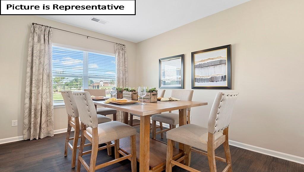 7022 North Mill Road Charlotte, NC 28216 - Photo 7 of 26 a view of a dining room with furniture and wooden floor