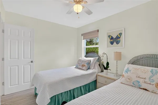 a bedroom with two beds and a chandelier