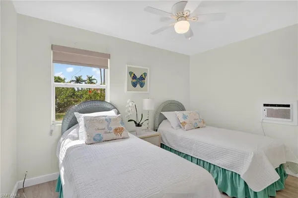 a bedroom with two beds and a chandelier