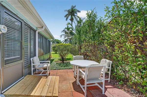 a patio with table and chairs