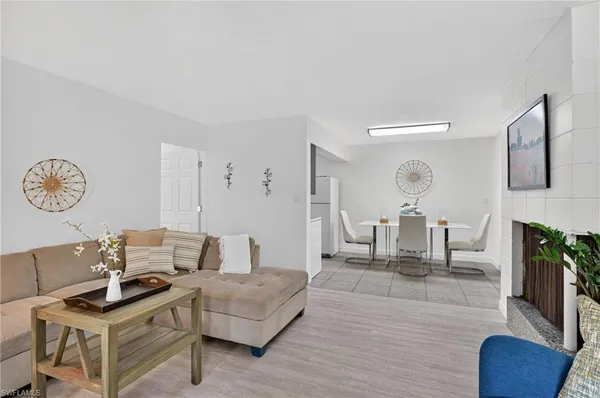 a living room with furniture a fireplace and a table