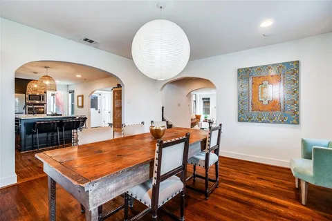 a view of a dining room with furniture and a chandelier