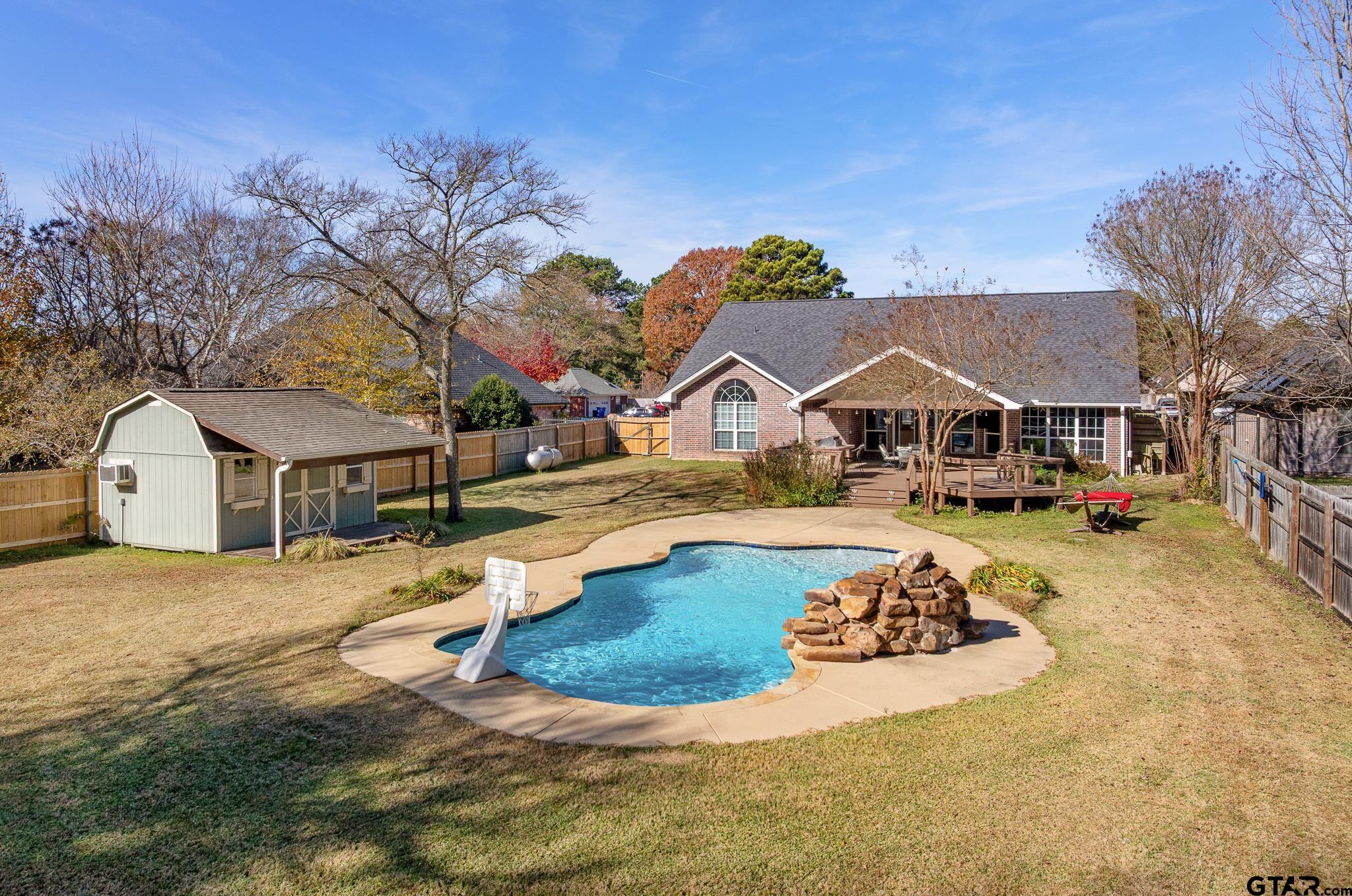 a view of house with outdoor space and swimming pool