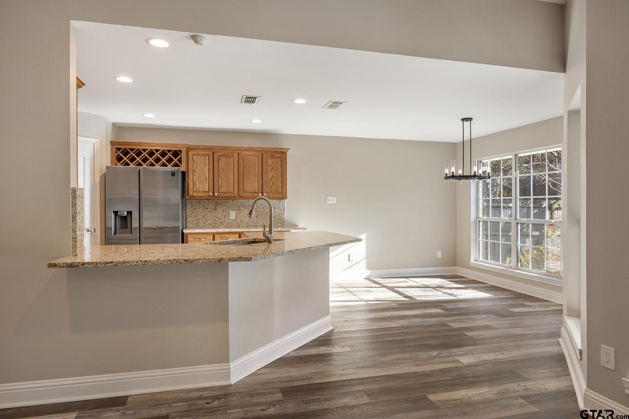 21237 Altuda Lane Flint, TX 75762 - Photo 12 of 48 a view of kitchen with granite countertop window and wooden floor