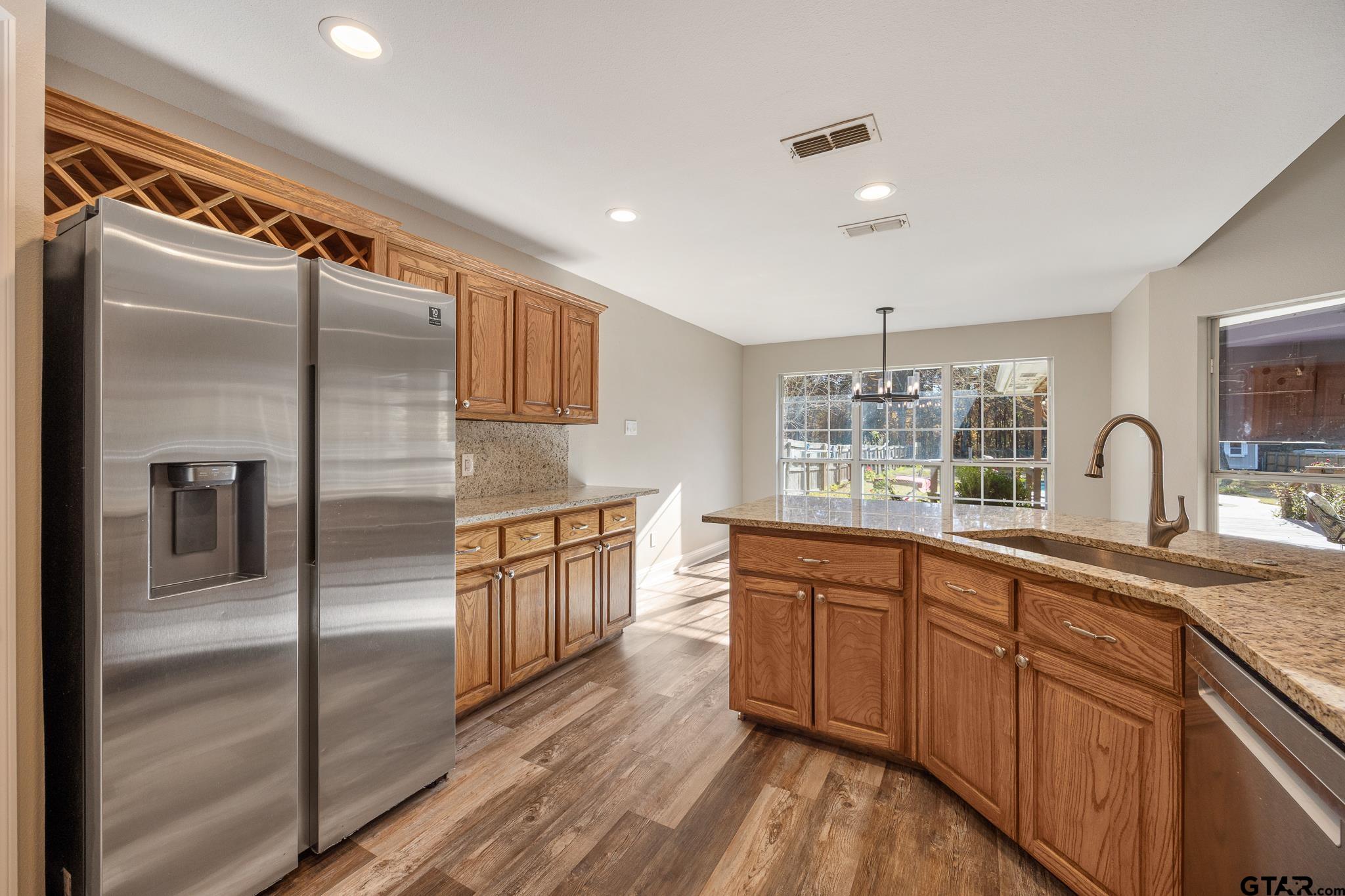 21237 Altuda Lane Flint, TX 75762 - Photo 17 of 48 a kitchen with stainless steel appliances granite countertop a refrigerator and a sink