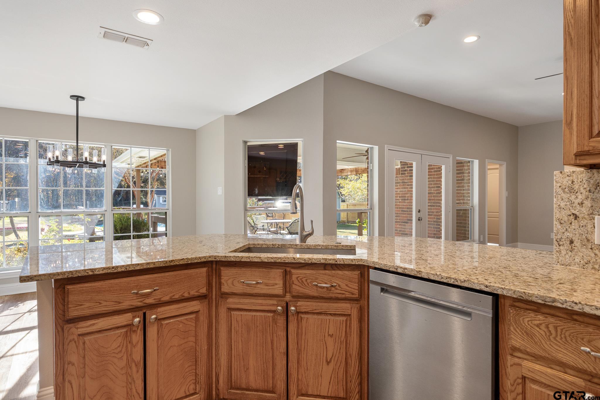 21237 Altuda Lane Flint, TX 75762 - Photo 18 of 48 a kitchen with granite countertop a sink and a window