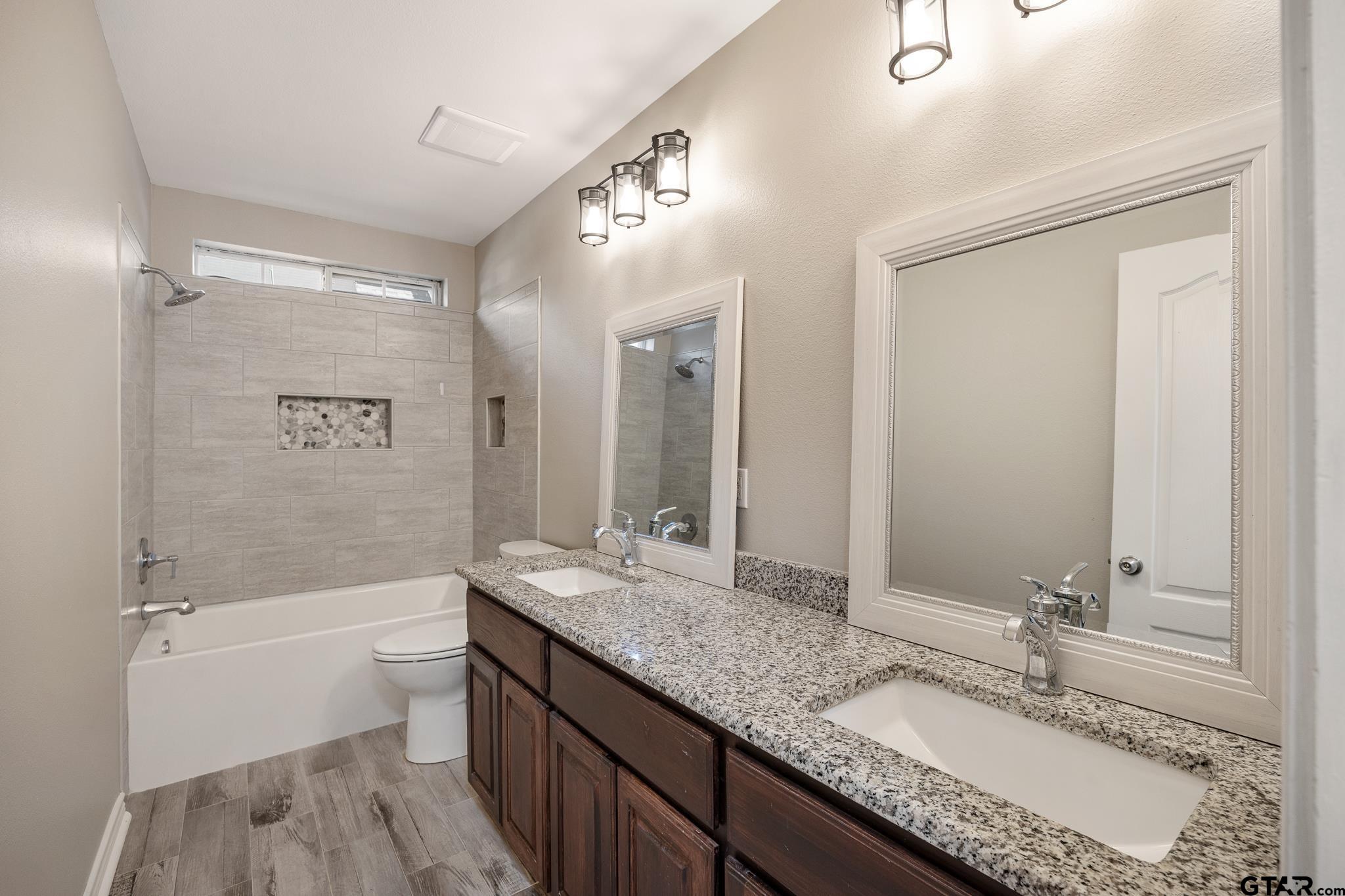 21237 Altuda Lane Flint, TX 75762 - Photo 28 of 48 a bathroom with a granite countertop tub sink and mirror