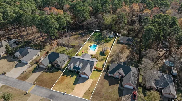 an aerial view of a backyard with table and chairs