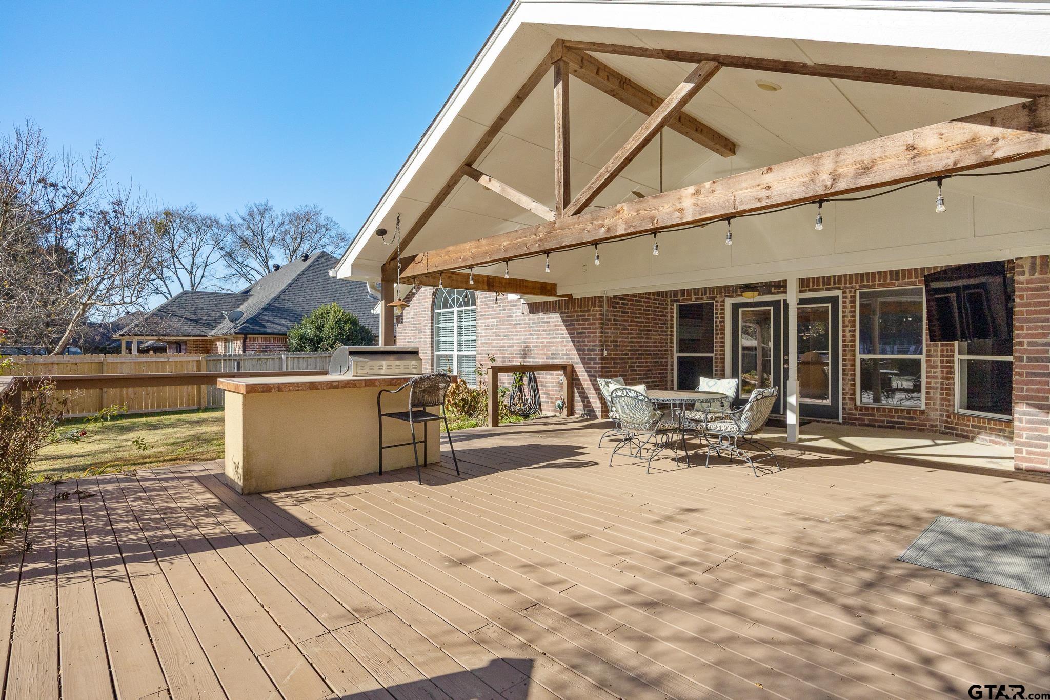21237 Altuda Lane Flint, TX 75762 - Photo 33 of 48 a view of a patio with table and chairs with wooden floor and fence