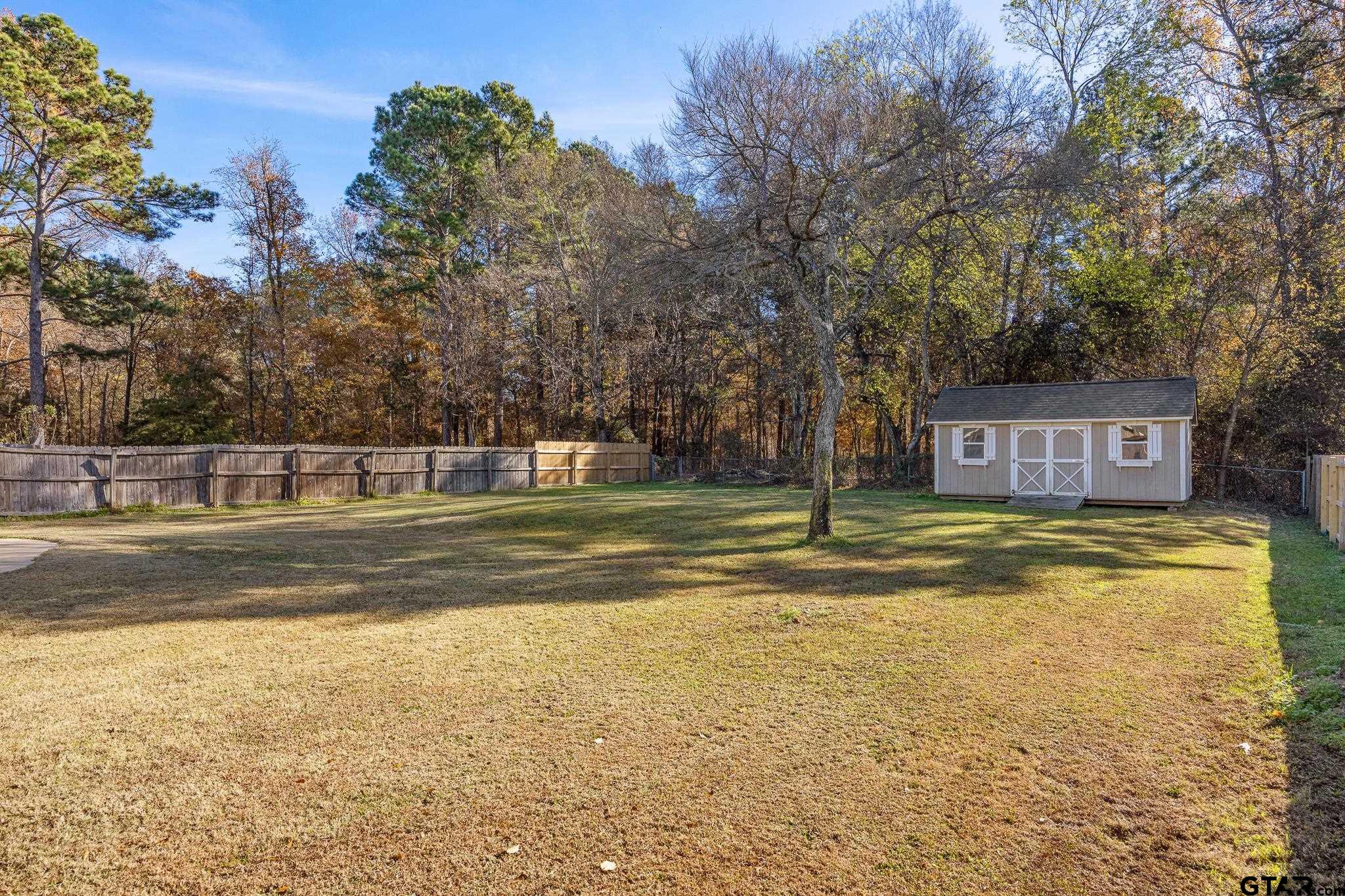 21237 Altuda Lane Flint, TX 75762 - Photo 38 of 48 a view of a swimming pool with a yard and large trees