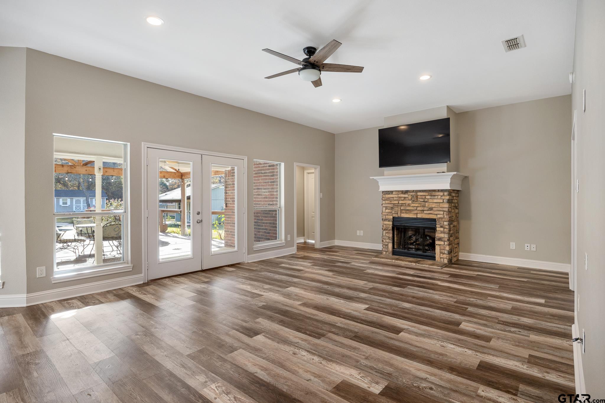 21237 Altuda Lane Flint, TX 75762 - Photo 10 of 48 a view of an empty room with a fireplace and a window