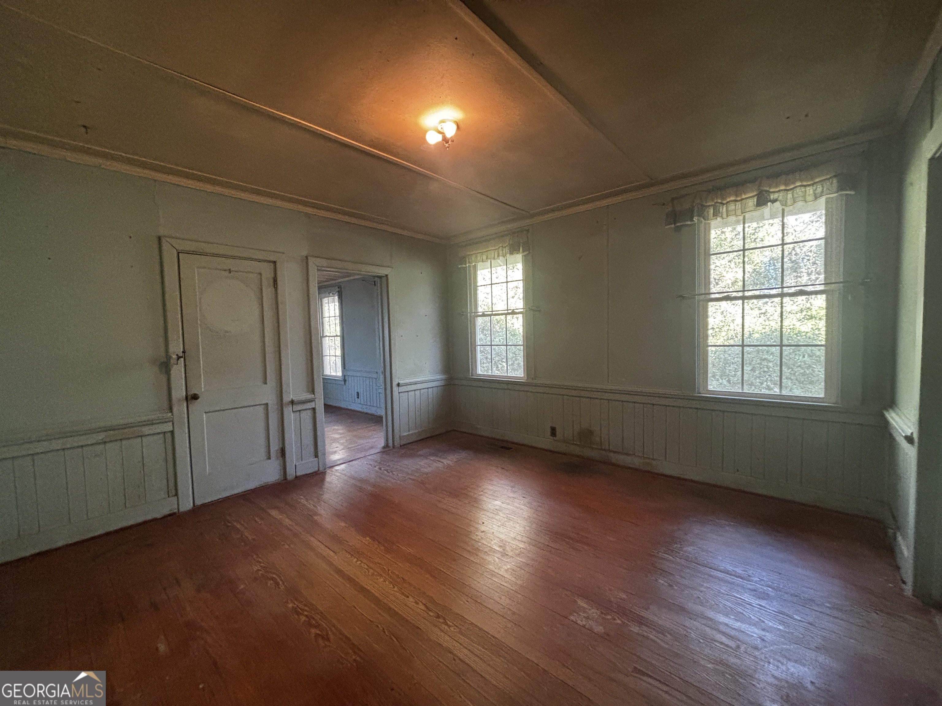 189 Whiteoak Campground Road Thomson, GA 30824 - Photo 18 of 32 an empty room with wooden floor and windows
