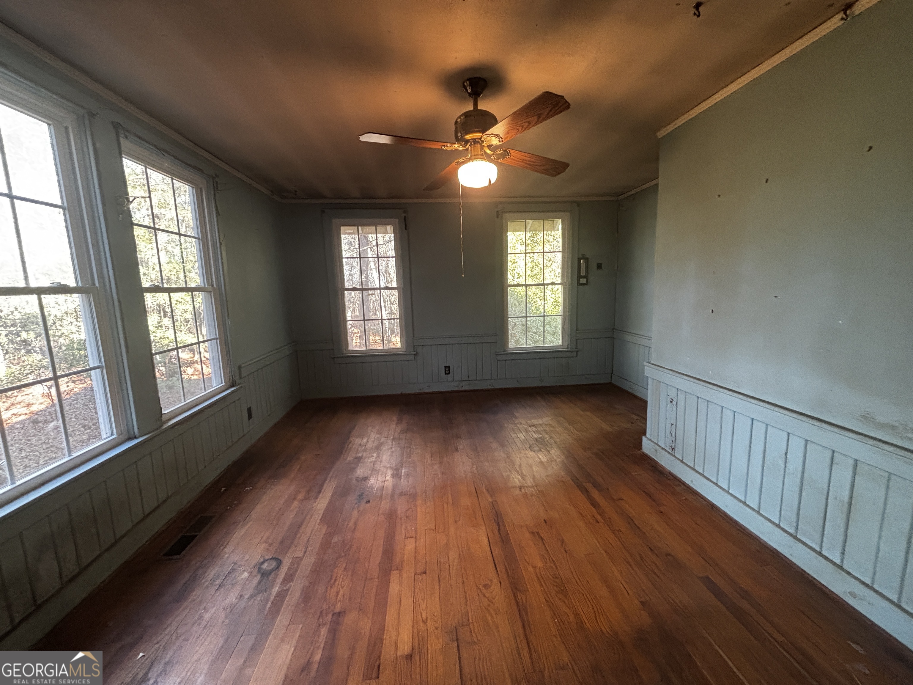 189 Whiteoak Campground Road Thomson, GA 30824 - Photo 20 of 32 a view of an empty room with wooden floor and a window
