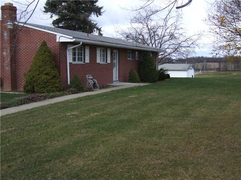 353 Riemer Road Sarver, PA 16055 - Photo 4 of 23 Exterior Back. NEARLY LEVEL YARD 1.21 ACRES IN SIZE ~ NICE LINE OF MAPLES IN REAR ~ CEMENT WALKWAY ~ A DETACHED WORKSHOP OR GARAGE WITH SMALL LOADING DECK AT ROAD ~ MULTIPLE USES