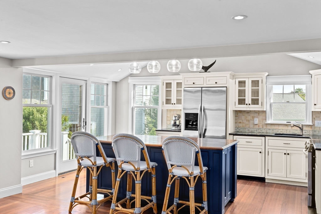 35 Ely Avenue Scituate, MA 02066 - Photo 11 of 33 a open dining room with stainless steel appliances granite countertop furniture a large window and wooden floor