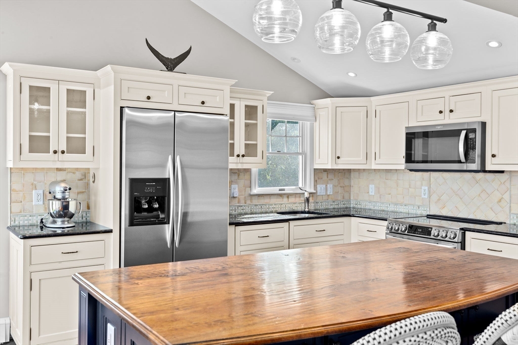 35 Ely Avenue Scituate, MA 02066 - Photo 15 of 33 a kitchen with stainless steel appliances granite countertop a sink a stove and cabinets