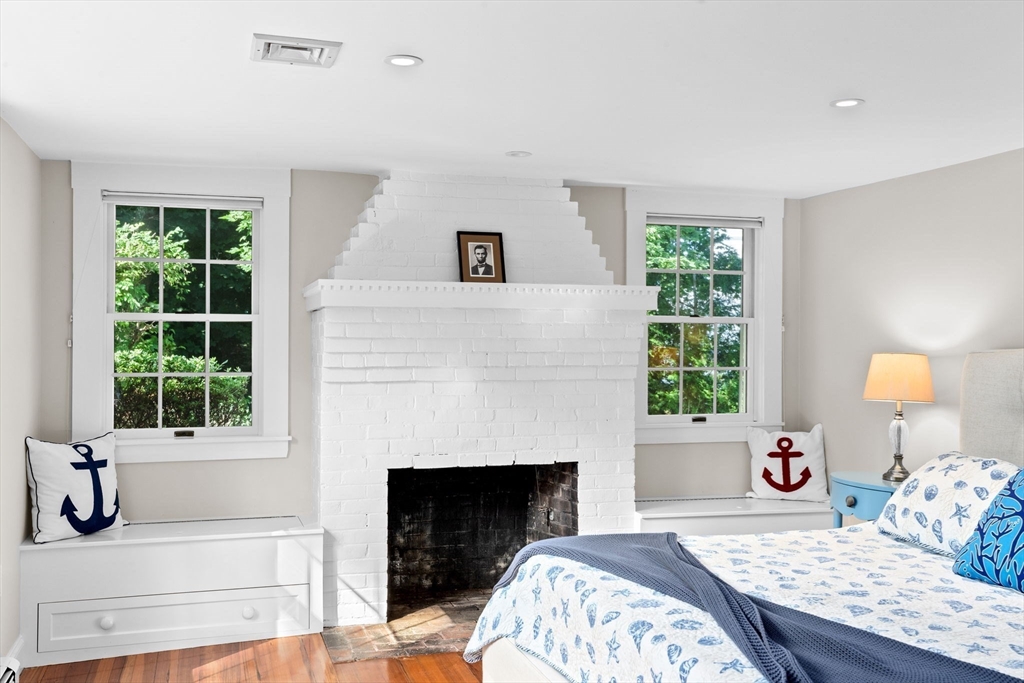 35 Ely Avenue Scituate, MA 02066 - Photo 20 of 33 a bedroom with a bed and a fireplace