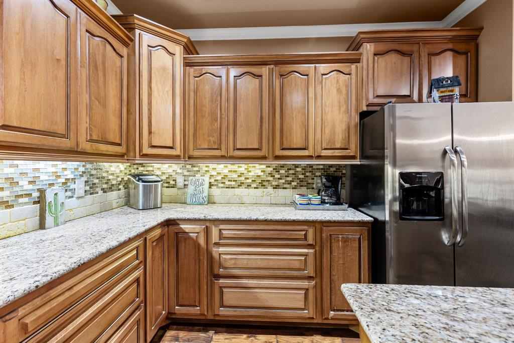 690 County Road Paris, TX 75462 - Photo 14 of 40 a kitchen with a refrigerator and cabinets