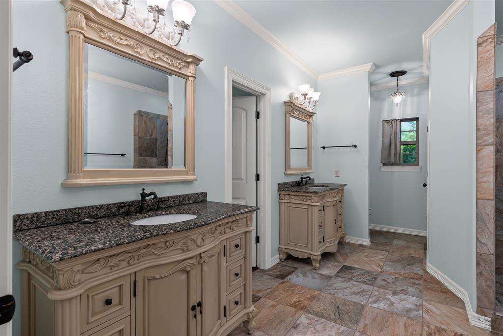 690 County Road Paris, TX 75462 - Photo 19 of 40 a bathroom with a granite countertop sink a toilet a mirror and vanity
