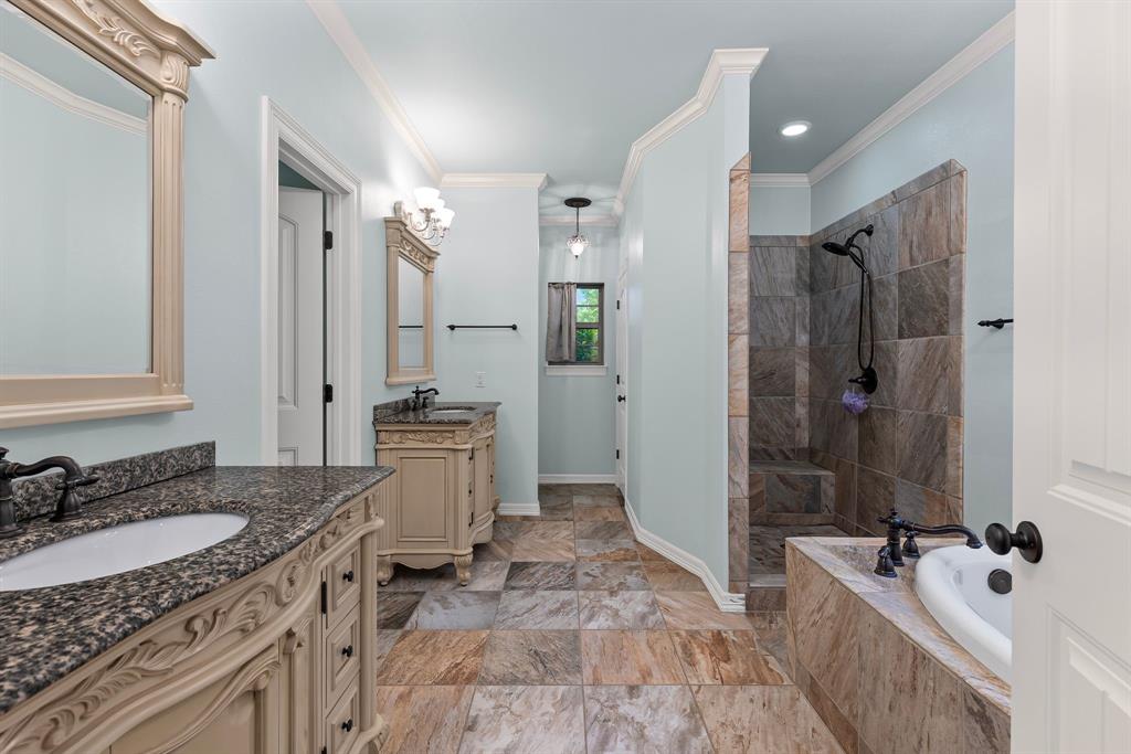 690 County Road Paris, TX 75462 - Photo 20 of 40 a bathroom with a granite countertop tub sink double vanity granite tub shower and mirror