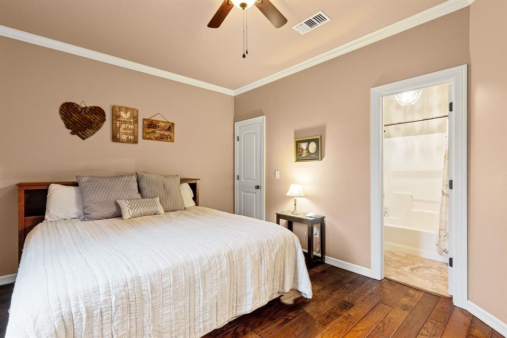 690 County Road Paris, TX 75462 - Photo 22 of 40 a bedroom with a bed and wooden floor