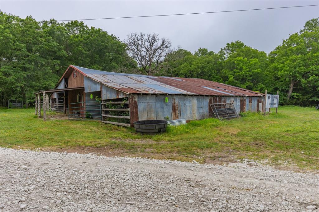 690 County Road Paris, TX 75462 - Photo 32 of 40 a backyard of a house with a garden and deck