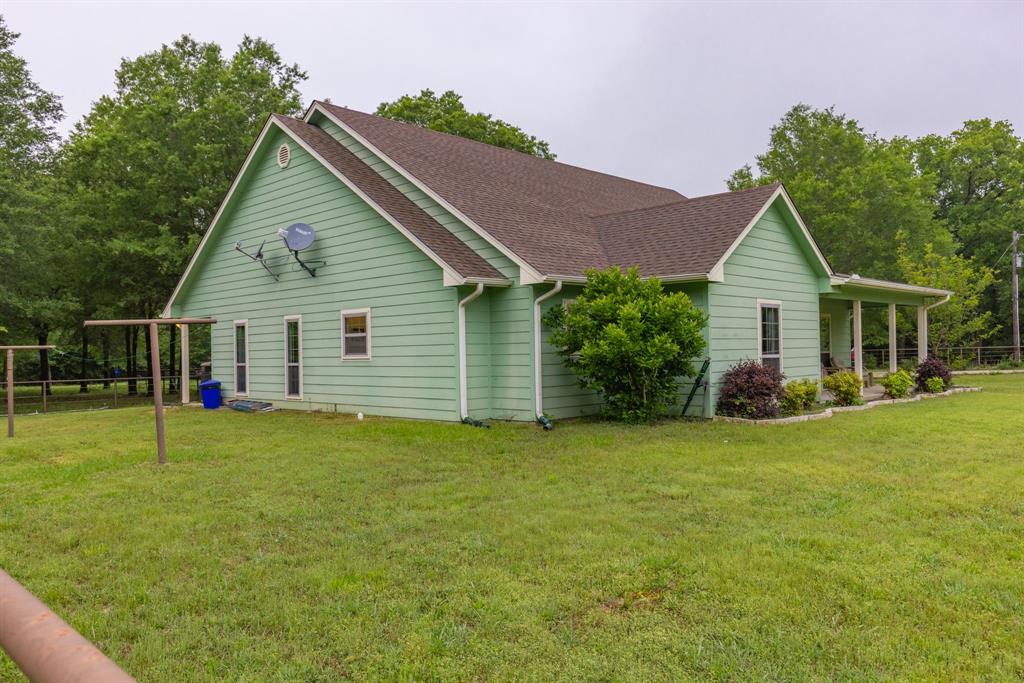 690 County Road Paris, TX 75462 - Photo 5 of 40 a view of a house with a backyard