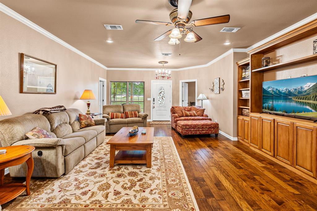 690 County Road Paris, TX 75462 - Photo 8 of 40 a living room with furniture and a flat screen tv