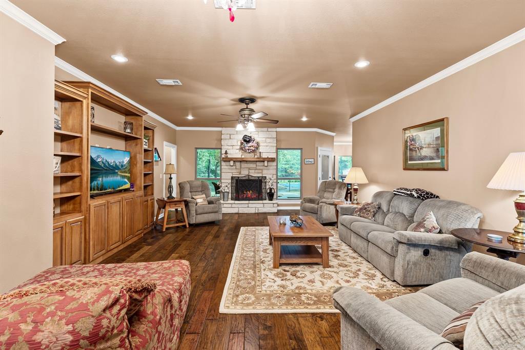 690 County Road Paris, TX 75462 - Photo 10 of 40 a living room with furniture fireplace and a flat screen tv