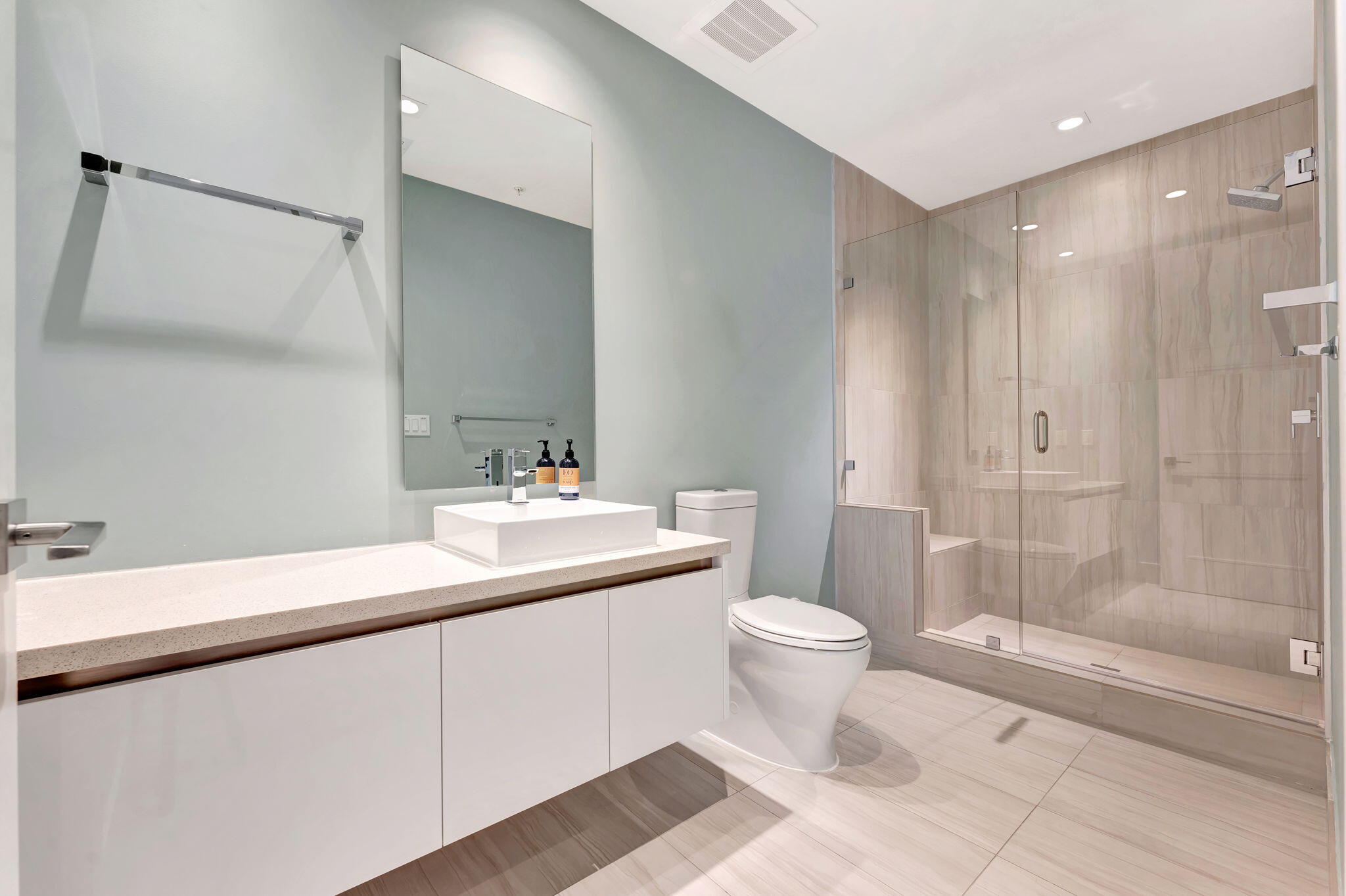 155 East Boca Raton Road, Unit 719 Boca Raton, FL 33432 - Photo 45 of 102 a bathroom with a double vanity sink toilet and shower